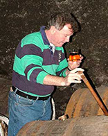 Jim McEwan of Bruichladdich Distillery sampling whisky from a 43 year old sherry cask in warehouse #1.